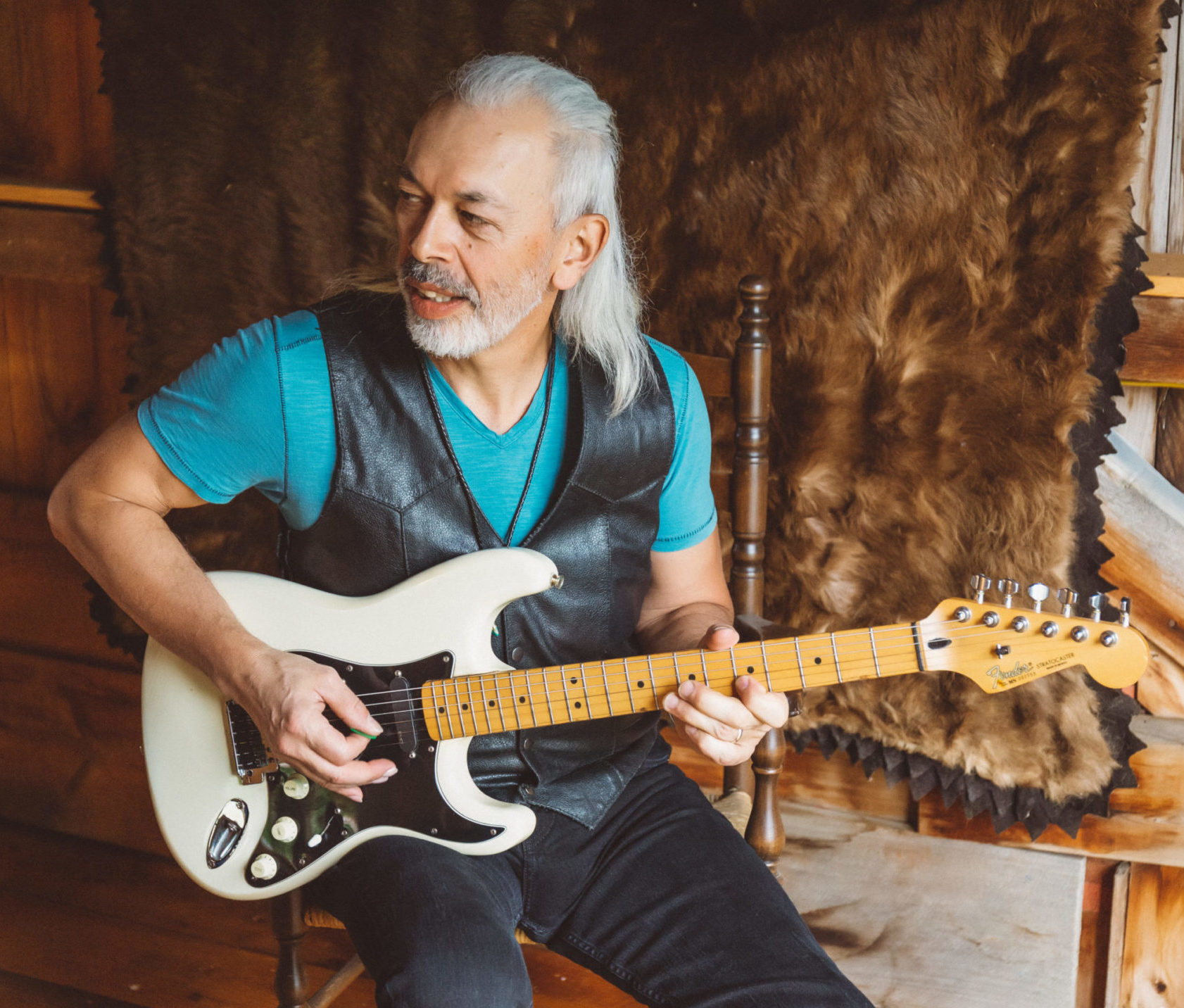 brumbylon-thebrandingedit-56 Brett sitting in front of bear rug wall haning, playing white stratocaster